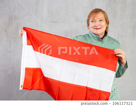Cheerful senior woman standing confidently with austrian flag Cheerful senior woman standing confidently with austrian flag 106117321