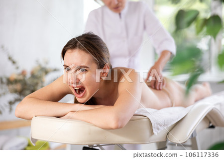 Young female client dissatisfied with work of masseuse 106117336
