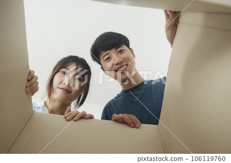 Asian young happy new married couple moving to their new house or real estate. Asian young happy new married couple moving to their new house or real estate. 106119760