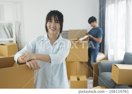 Asian young happy new married couple moving to their new house or real estate. Asian young happy new married couple moving to their new house or real estate. 106119761