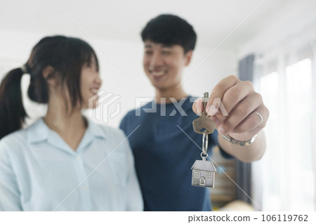 Happy young couple buying a new house receiving the keys. Happy young couple buying a new house receiving the keys. 106119762