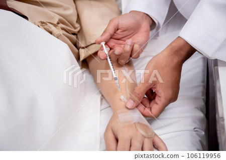 Hands of doctor hold syringe needle insulin with preparing vaccinate for treatment patient elderly. 106119956