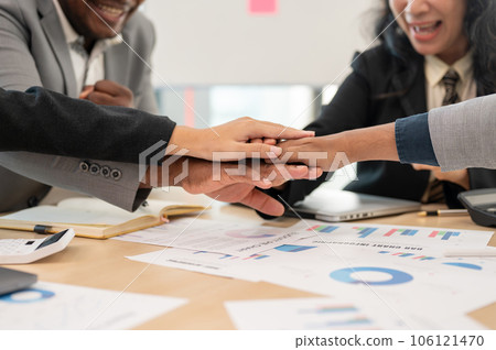 Close-up image of a multiracial business people is in a meeting, putting hands together Close-up image of a multiracial business people is in a meeting, putting hands together 106121470