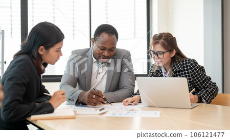 A smart African American male boss is co-working with Asian employees A smart African American male boss is co-working with Asian employees 106121477