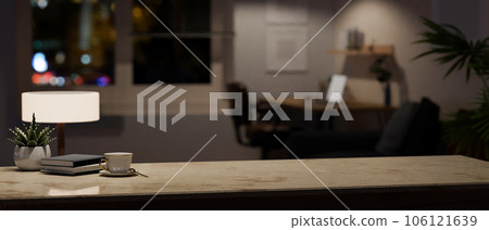 Copy space on a marble tabletop in a modern home office room at night. Copy space on a marble tabletop in a modern home office room at night. 106121639