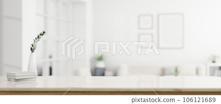 A modern white workspace with copy space over a blurred modern white living room 106121689