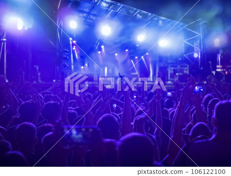 Crowd raising their hands and enjoying great festival party or concert. 106122100