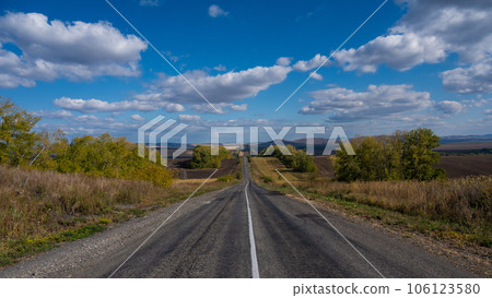 Road landscape. Empty track among mountains and fields in autumn. Road landscape. Empty track among mountains and fields in autumn. 106123580