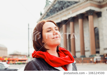 caucasian female woman with closed eyes on street of historic european city. 38 years old. dreams, resting, wellbeing happy concept. close up portrait 106124500