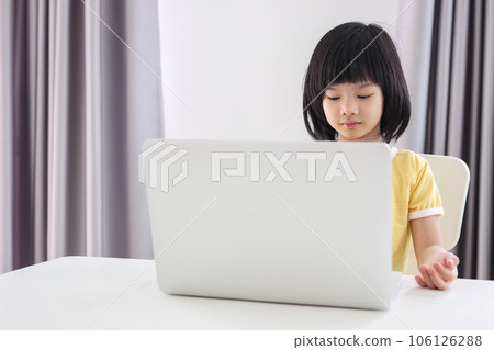 little asian girl student study online using laptop computer at home 106126288