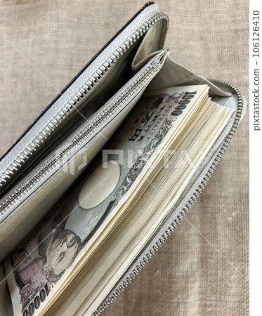 錢包裡裝著一捆 10,000 日元的鈔票 錢包裡裝著一捆 10,000 日元的鈔票 106126410