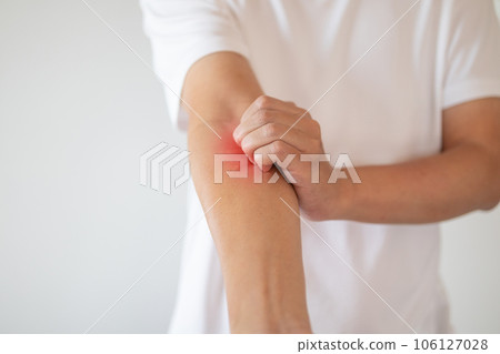 man itching and scratching on arm from itchy dry skin eczema dermatitis 106127028