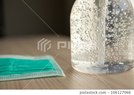 Medical face mask with alcohol sanitizer gel hand wash on wood table for covid-19 Coronavirus prevention concept 106127066