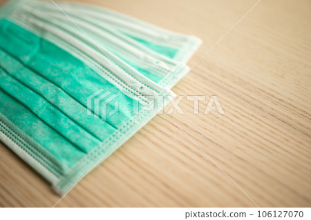 Medical face mask on wood table for covid-19 Coronavirus prevention concept 106127070
