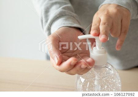 Woman using alcohol sanitizer gel rub for cleaning hand COVID-19 corona virus prevention concept 106127092