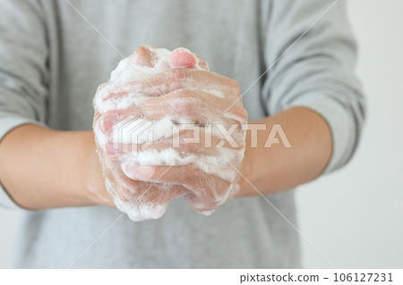 Man wash hands with soap for COVID-19 corona virus prevention concept 106127231