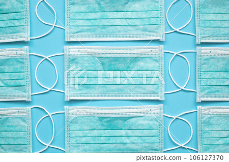 Surgical face mask on blue background protection against COVID-19 coronavirus. Healthcare and medical concept Surgical face mask on blue background protection against COVID-19 coronavirus. Healthcare and medical concept 106127370