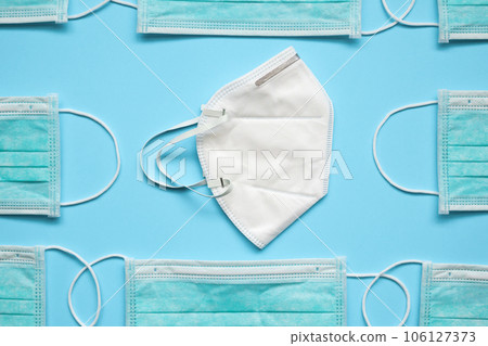 KN95 and surgical face mask on blue background protection against pm 2.5 polution and COVID-19 coronavirus. Healthcare and medical concept 106127373