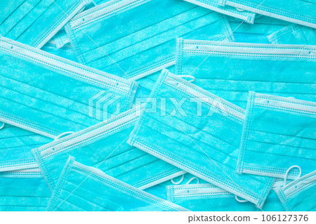 Blue surgical face mask texture background protection against air pollution and COVID-19 coronavirus. Healthcare and medical concept Blue surgical face mask texture background protection against air pollution and COVID-19 coronavirus. Healthcare and medical concept 106127376