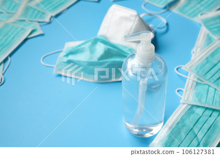 KN95 Medical face mask with alcohol sanitizer gel hand wash bottle on blue background covid-19 Coronavirus prevention concept KN95 Medical face mask with alcohol sanitizer gel hand wash bottle on blue background covid-19 Coronavirus prevention concept 106127381