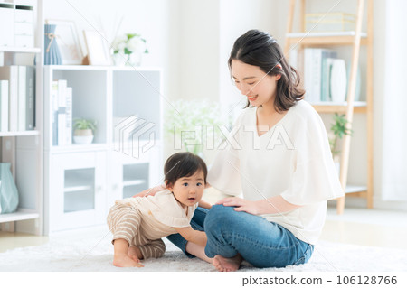 Mother playing with baby in the living room Mother playing with baby in the living room 106128766