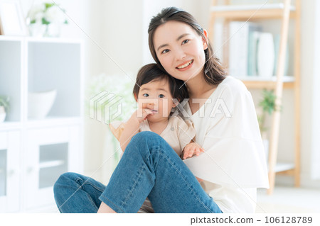 Mother playing with baby in the living room 106128789