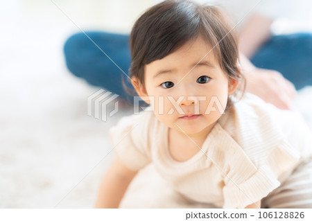 Mother playing with baby in the living room Mother playing with baby in the living room 106128826