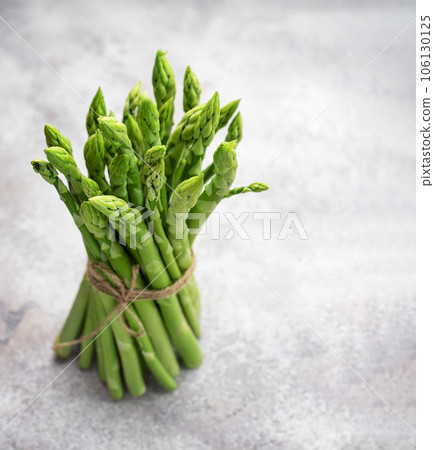 Fresh green asparagus on  concrete background. 106130125