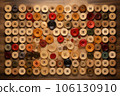 thread spools and buttons arranged in a creative pattern 106130910