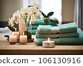 folded towels in a spa-like arrangement with candles 106130916