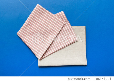 top view with red empty kitchen napkin isolated on table background. Folded cloth for mockup with copy space, Flat lay. Minimal style top view with red empty kitchen napkin isolated on table background. Folded cloth for mockup with copy space, Flat lay. Minimal style 106131201