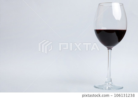 One glasses of red wine at wine tasting. Concept of red wine on colored background. Top view, flat lay design One glasses of red wine at wine tasting. Concept of red wine on colored background. Top view, flat lay design 106131238