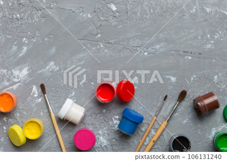 art palette with paint and brushes, close up. Top view with empty space. workplace for creativity. home teaching concept drawing art palette with paint and brushes, close up. Top view with empty space. workplace for creativity. home teaching concept drawing 106131240