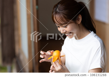 Woman eating fruit on the porch Woman eating fruit on the porch 106131288