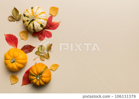Autumn composition. Pattern made of dried leaves and other design accessories on table. Flat lay, top view Autumn composition. Pattern made of dried leaves and other design accessories on table. Flat lay, top view 106131379