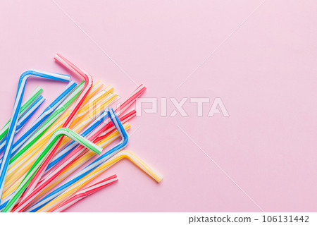 Heap of colorful plastic drinking straws on Colored background, flat lay. Copy Space for text Heap of colorful plastic drinking straws on Colored background, flat lay. Copy Space for text 106131442