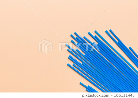 Heap of colorful plastic drinking straws on Colored background, flat lay. Copy Space for text 106131443