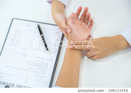 Doctor hand examines the patient's pulse and records the results, health medical checkup concept Doctor hand examines the patient's pulse and records the results, health medical checkup concept 106131458