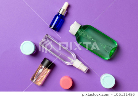 Cosmetics SPA branding mock-up, top view with copy space. set of tubes and jars of cream flat lay on colored background 106131486