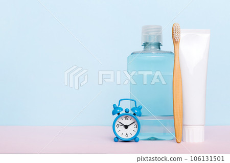 Mouthwash and other oral hygiene products on colored table top view with copy space. Flat lay. Dental hygiene. Oral care products and space for text on light background. concept 106131501