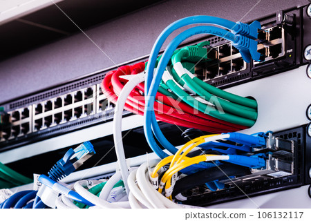 colorful patch cables connected to switch - high speed internet concept 106132117