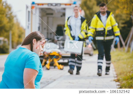 Medic and emergency doctor approaching site of accident Medic and emergency doctor approaching site of accident 106132542