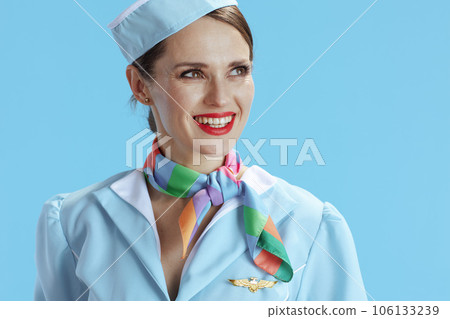 happy elegant female flight attendant on blue looking aside happy elegant female flight attendant on blue looking aside 106133239