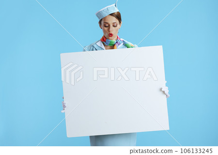 surprised modern air hostess woman on blue showing blank board surprised modern air hostess woman on blue showing blank board 106133245