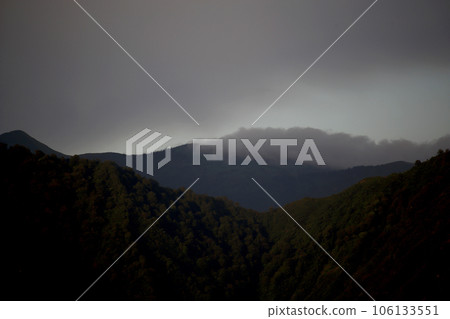 Mountain range ridgeline silhouette and fantastic clouds Mountain range ridgeline silhouette and fantastic clouds 106133551