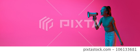 Young girl,. student shouting in megaphone against pink studio background in neon light. News, information, propaganda Young girl,. student shouting in megaphone against pink studio background in neon light. News, information, propaganda 106133681