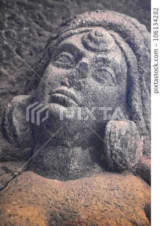 A Close Up Carved Women's Face Detail on right in the courtyard of Karla Chaitya, these Caves was constructed between 50 and 70 CE, and 120 CE, located near the Karla, Lonavala in Pune Dist. A Close Up Carved Women's Face Detail on right in the courtyard of Karla Chaitya, these Caves was constructed between 50 and 70 CE, and 120 CE, located near the Karla, Lonavala in Pune Dist. 106134282