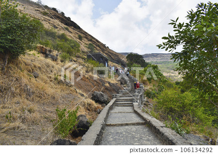 INDIA, MAHARASHTRA, PUNE,  May 2023, People at steps to the Bhaja Caves, Ancient Buddhist built in 2nd century BC, during the Hinayana phase of Buddhism, Lonavala 106134292