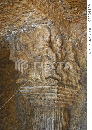 Sculptures on the top left pillar of Vihara Cave No. 20 with rock-cut at Bhaja Caves, Ancient Buddhist built in 2nd century BC, during the Hinayana phase of Buddhism, Lonavala, Maharashtra, India. 106134309