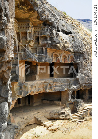 Vertical view showing Entire Cave 12 Vihara Cell Doors and Stairs with rock-cut, Bhaja Caves, Ancient Buddhist built in 2nd century BC, during the Hinayana phase of Buddhism, Lonavala, Maharashtra, 106134321